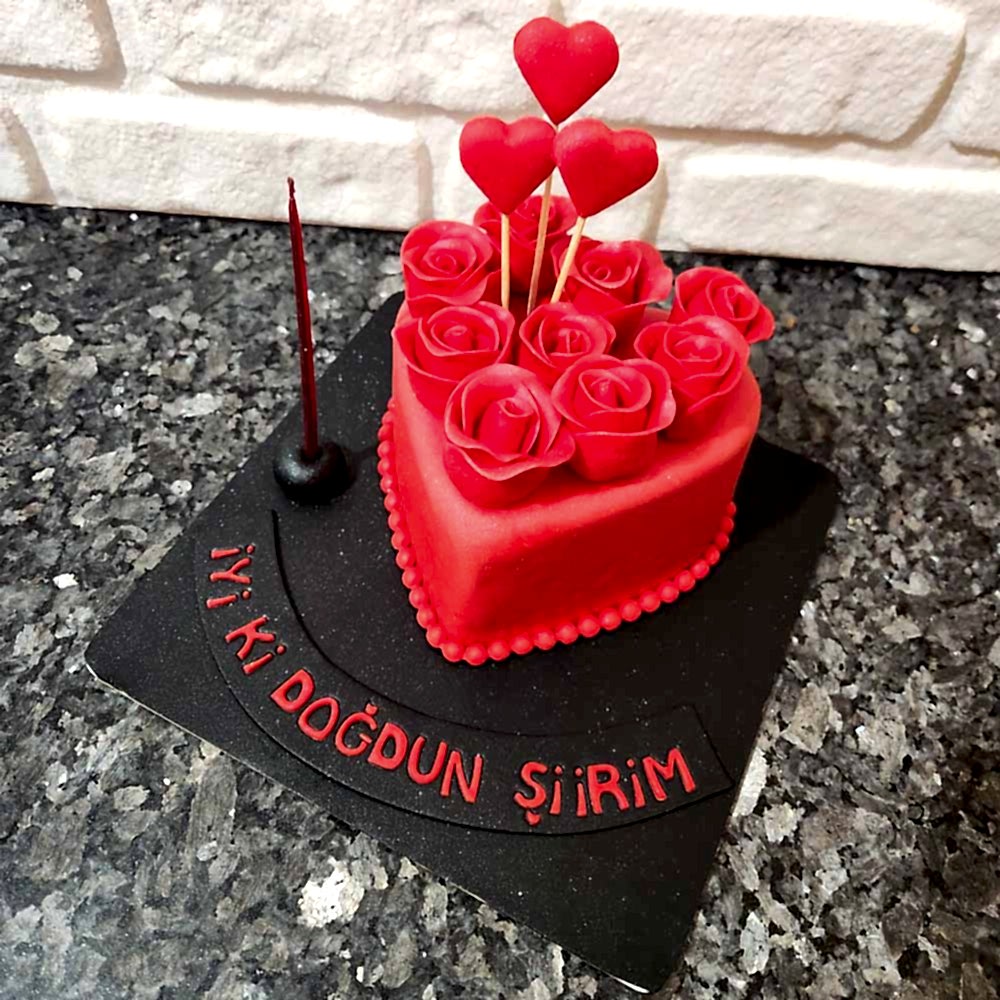 Kalp figürleri ve zarif güllerle süslenmiş romantik butik pasta. Aşk dolu kutlamalar için özel tasarım.